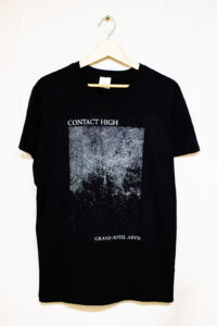 A black shirt with a white print of the album cover art. It reads "Contact High" and "Grand Budapest Hotel" in between those texts is an abstract gradient of points. It is seen from the front.