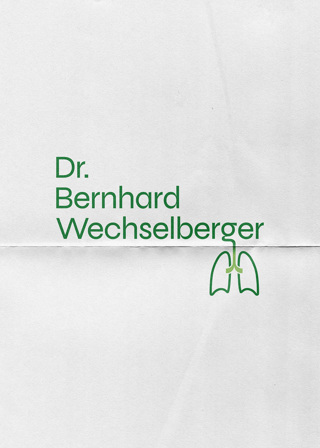 The logotype for Dr. Wechselberger on a piece of folded paper