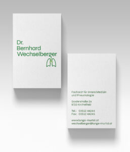 The front and back of the business card with the three-lined version of the green logo in the front and the business info on the back, also in green.